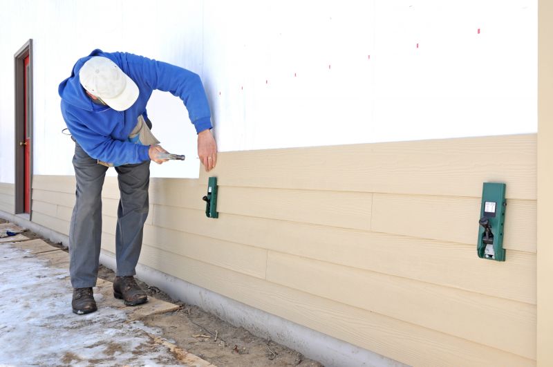Installing siding panels on a house
